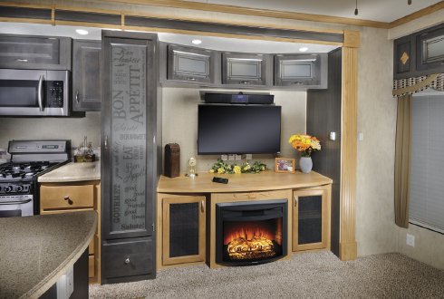 The large entertainment center with optional fireplace not only gives ample storage and space for your large TV, it adds to the open feel of the living room area.